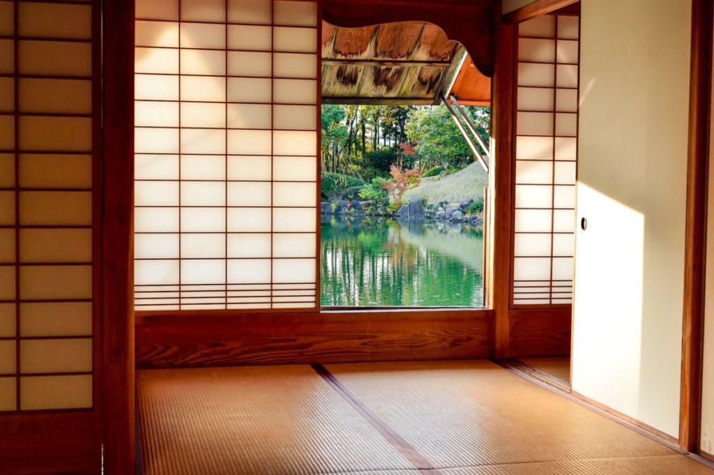 Room of a Japanese ryokan looking out onto a Japanese garden
